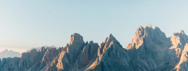 Fototapete Dolomiten mountain ridge in the dolomites at sunrise with a blue sky