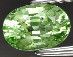 natural green tsavorite garnet gem on the background