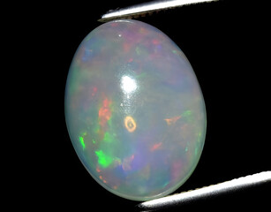 natural multi color rainbow opal gem on the background