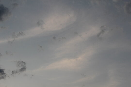 The evening sky has light shining through the clouds.