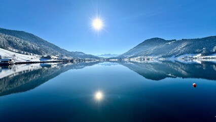Sunny lake in the mountains in winter