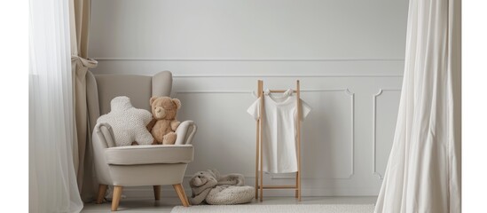 Contemporary, simple kid's room with a cozy gray chair, stuffed animal, and white t-shirt on wooden stand.