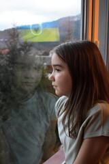 child looking out window, country flag, independence and freedom, war in Ukraine