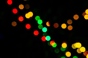 Abstract blurred with dark background of Colorful Led serial bulb in shallow depth effect, Festival decorations with led serial lights. All color led lights. Glowing lights. lights bokeh shot.