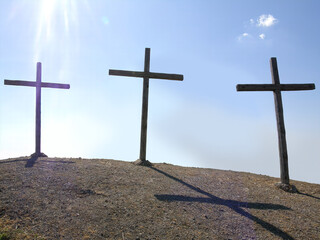 Three wooden crosses on a hill in the morning. Concept of Crucifixion on Mount Golgotha,...