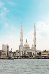 Fototapeta na wymiar Port Fouad Grand Mosque. suez canal with a grand mosque and blue cloudy sky. Port-said , Egypt 
