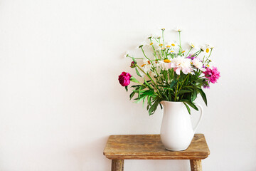 Still life with flower bouquet in white vase