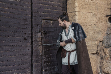 Medieval Swordsman by Historic Castle Gate