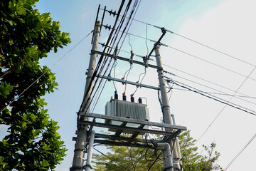 Urban energy grid infrastructure featuring a utility pole with a high-voltage transformer and a...