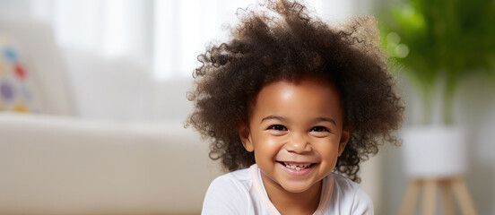 Portrait of a happy cute African American kid with afro fluffy hair looking at the camera. Black beautiful happy smiling healthy child. Banner. Copy space for text - obrazy, fototapety, plakaty