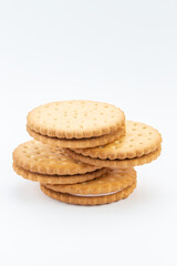 Stacked sandwich biscuits with pink cream filling. Sandwich cookies lie one on top of the other