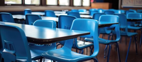 Blue desks and chairs in an empty classroom.