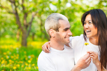 Obraz premium Happy smiling couple in love in spring garden