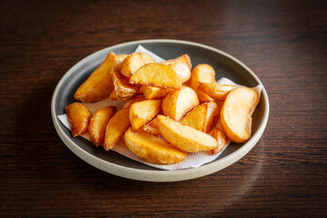 French fries in wedges in a plate.