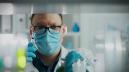 Medicine preparation process. The anesthesiologist wearing protective gloves carefully prepares the necessary medicine for anesthesia. An experienced medical specialist fills syringe with modern drug - Powered by Adobe