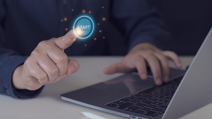 Businessman designer touching virtual button start. New start, beginning, business concept