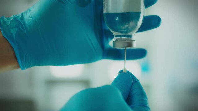 Disease. The procedure while wearing protective gloves effectively sets up iv drip in the operating room. Stable camera movement, experienced assistant installs iv drip using modern technology, drips