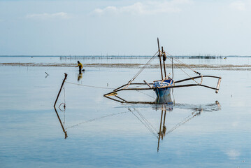 pêcheuse marchant derrière son bateau aux philippines