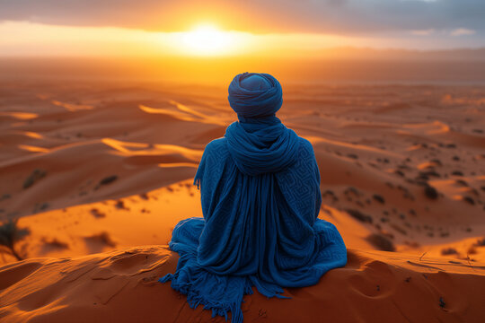 person sitting on the sand, a berber