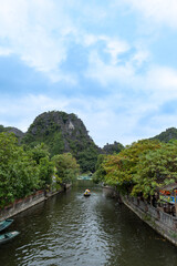 Fototapeta na wymiar Ninh Binh landscpae in Vietnam. Tam Coc lake area with boat, Karst landscape and river