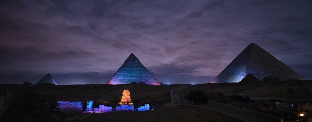 Giza, Egypt - December 24 2023: The Pyramids and the Sphinx in the night lights