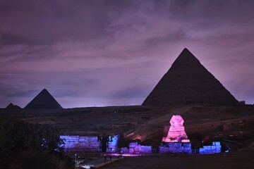 Giza, Egypt - December 24 2023: The Pyramids and the Sphinx in the night lights