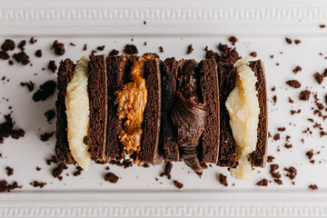 Stack of chocolate brownie and filling with dulce de leche, powdered milk, milk brigadeiro and beijinho