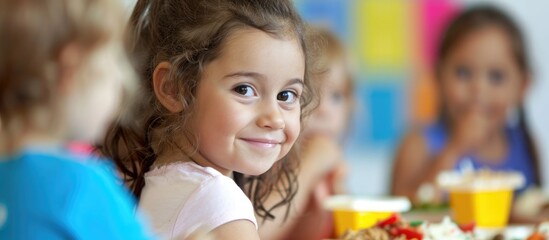 Children in day care center eating nutritious meals. - obrazy, fototapety, plakaty