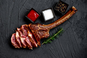 Grilled Tomahawk steak on stone background 