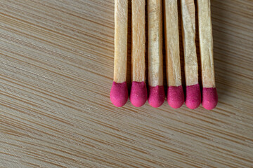Many matches on the wooden table, closeup