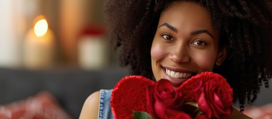 Man giving heart-shaped box and red roses to happy African American woman on February 14th, sign.