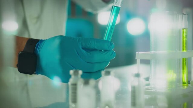 Biochemistry. A scientific research expert wearing protective gloves works on samples in modern laboratory. A professional worker carries out scientific experiments using modern research technologies