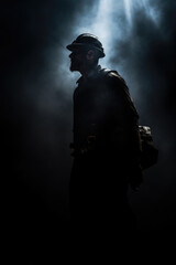 Fototapeta na wymiar Silhouette photo of miner worker in dark night atmosphere