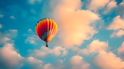 Poster a hot air balloon flying through a cloudy blue sky © KWY