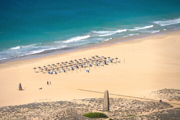 view from a mountain towards the dunes and a wonderful beach with parasols at the Atlantic Ocean,...