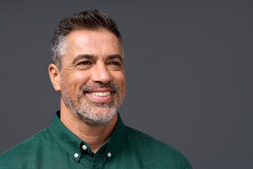 Happy middle aged business man entrepreneur, smiling mature professional confident businessman leader investor wearing green shirt looking aside isolated on gray, headshot close up portrait. - obrazy, fototapety, plakaty