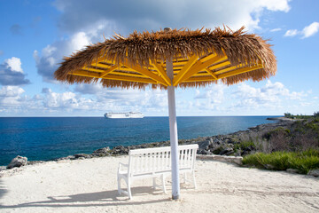 Little Stirrup Cay Bench With Straw Umbrella