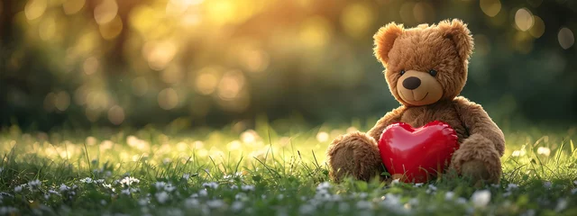 Foto op Plexiglas Teddy bear with a red heart shaped balloon on blurred nature background. Cute bear toy holding heart. Valentine's day. Love and romantic concept © ratatosk