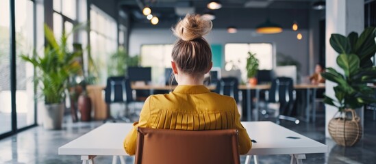 A young woman is at ease in a contemporary office.