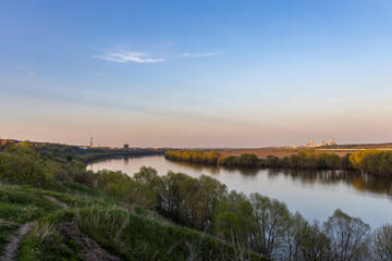 Obraz premium Industrial landscape near the river, large factory next to the river