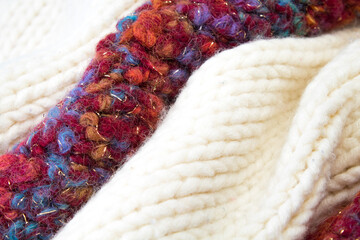 Knitted woolen sweaters. A bunch of knitted winter, autumn clothes, sweaters, knitwear, space for the text.