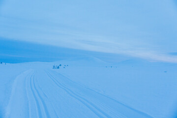 Fototapeta na wymiar The blue hour in the Norwegian winter mountain landscape