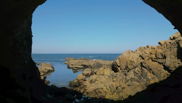 Drone pullback footage in a Coastal Cave with Sea view on the Coast of Caion in Coruna, Spain