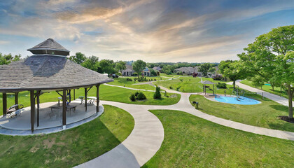 suburban neighborhood park with playgrounds, walking paths, and a gazebo, surrounded by family homes