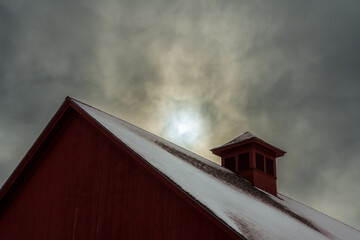 Barn roof on overcast day with hazy sun