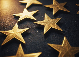 Close-up of scattered golden stars on a dark surface, conveying a sense of luxury and achievement