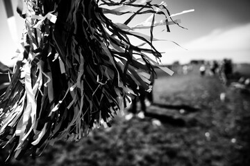 Selective focus on a pom-pom streamer with defocused child running in the background 