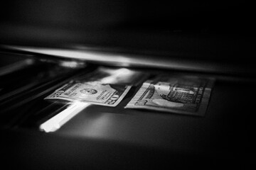 Using a copy machine to print forgery currency. 