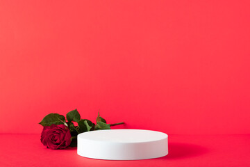 Abstract empty white podium with rose on red background