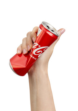 Berlin Germany December 21 2023 Squeezed metal can, steel tin bottle in hand isolated on white